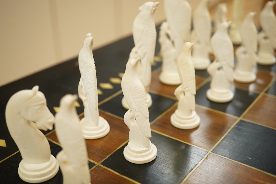 A Sri Lankan chess table and a boxed bone chess set, table measures 62cm high. Condition - good